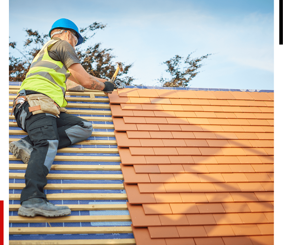 Man hammering on roof tiles
