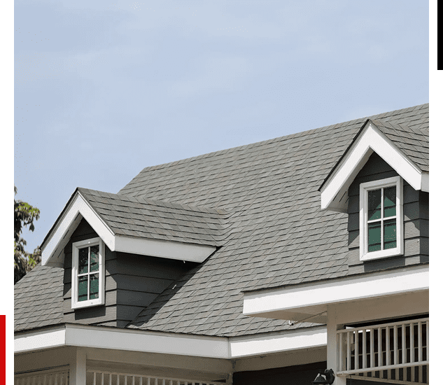 Gray shingled roof with dormer windows on a residential house.