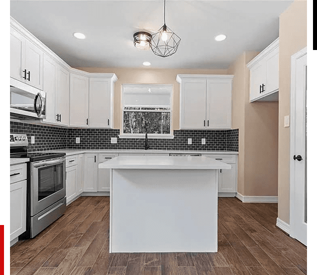 Modern white kitchen with island and stainless steel appliances.