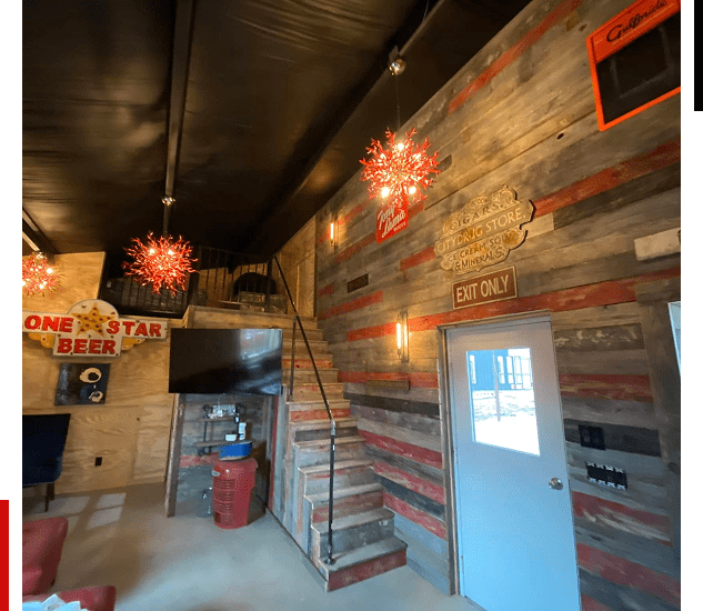 Rustic interior with wooden walls and unique star-shaped light fixtures.